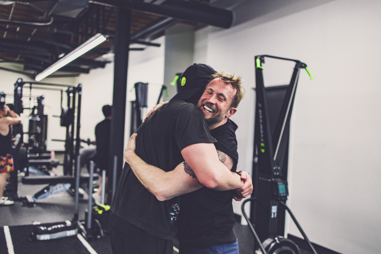 Coach and athlete embrace after training